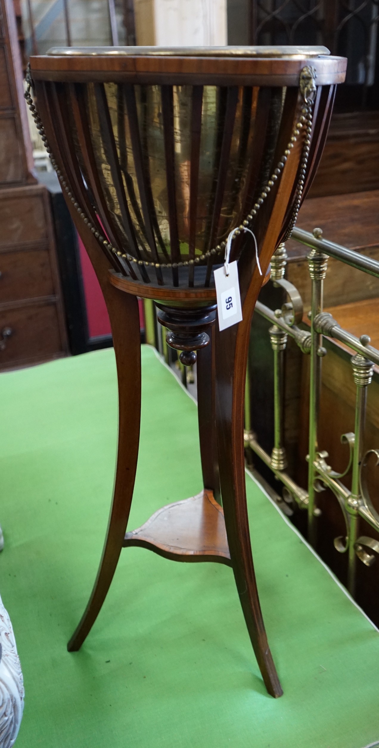 An Edwardian satinwood banded mahogany jardiniere with brass liner, diameter 35cm, height 85cm.